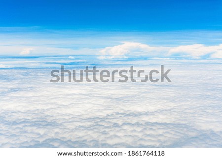 Take pictures of clouds in the sky while flying