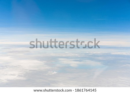 Take pictures of clouds in the sky while flying
