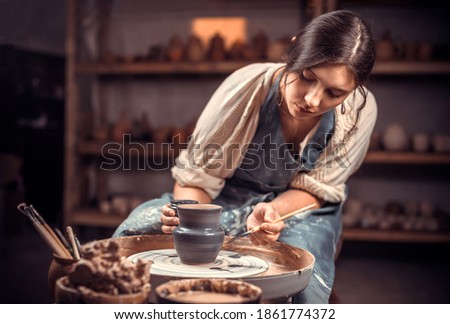 Processing clay ware and making dishes, process. Ceramics of handwork and clay ware on the potter's wheel. Royalty-Free Stock Photo #1861774372