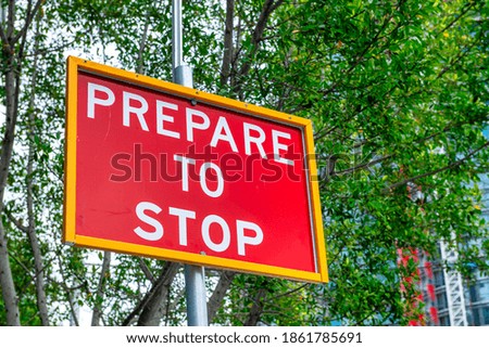 Prepare to stop sign, road alert in central city.