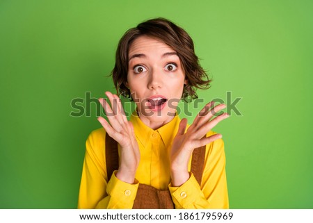 Photo of excited surprised girl palms face wear yellow shirt overall isolated green color background