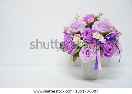 Close-up for vase of purple rose flowers and dark purple ribbon for special day ,birthdays and Congratulation with white background