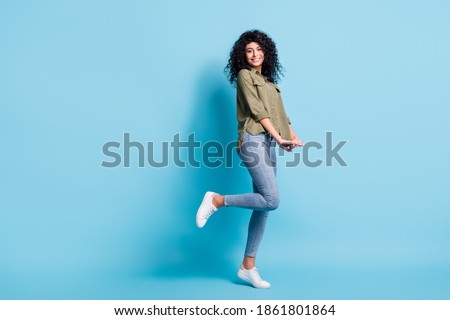 Full body profile photo of gorgeous person toothy smile bent feet isolated on pastel blue color background