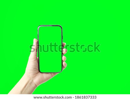 Women hand holding smartphone isolated on green background Royalty-Free Stock Photo #1861837333