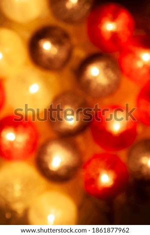 Defocused close-up on a garland of balls of thread. Festive colorful background for christmas cards.