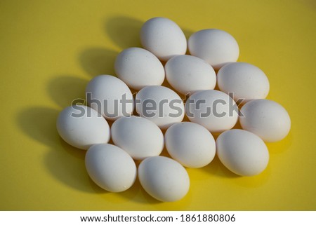 Tray of white fresh eggs close-up on a cardboard form. Agricultural industry. Close-up of many white eggs background.