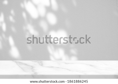 White Marble Table with Nature Leaves Shadow and Bokeh on Concrete Wall Texture Background, Suitable for Product Presentation Backdrop, Display, and Mock up.