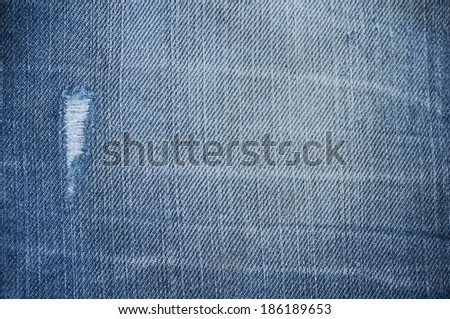 Blue denim texture, dark jeans with hole