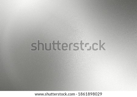 Glowing silver gray foil metal wall with copy space, abstract texture background