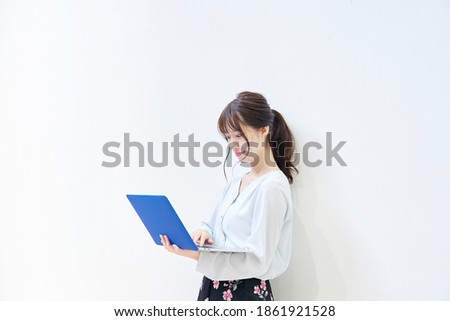 Asian woman using the laptop in the white background