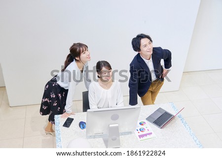 Asian office workers working with the PC