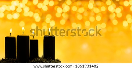 Advent candles in front of a golden blurred background