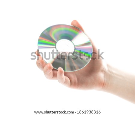 Hand holding a CD. Close up. Isolated on a white background.