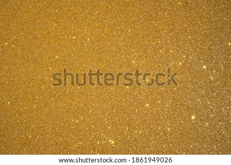 Trendy color Fortuna gold background with glitter and feather. Christmas texture