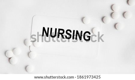 On the business card, the text is NURSING, next to white pills.