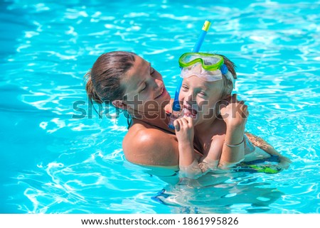 Mother with child having fun in pool