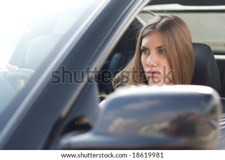 Image of pretty businesswoman in her car driving