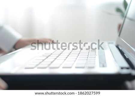 A blurry picture of a laptop computer lying on a desk