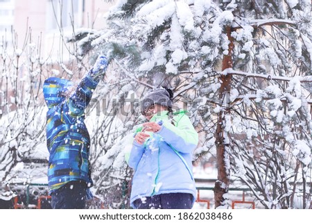 Kids playing with snow. Authentic moment of happiness