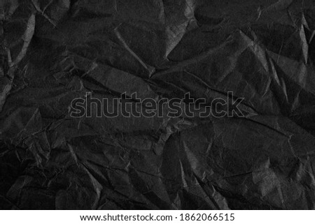 Background with Black crumpled sheet of paper with vignetting