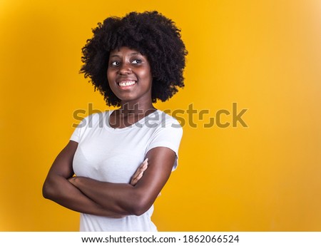 black woman with arms crossed on yellow background