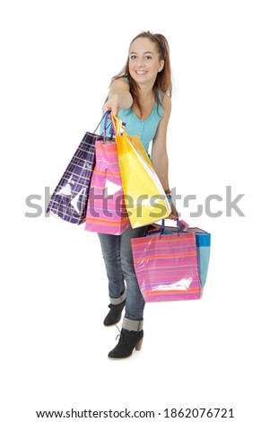 Happy young girl doing bargain shopping and showing her bags of gifts. Subject full-length photography on white background