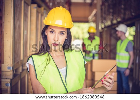Female engineer holding Ipad at the warehouse store after the factory reopening from the Covid-19 pandemic
