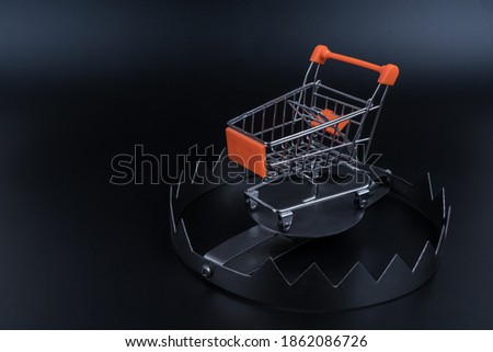 Trolley for shopping in a trap. Black Friday concept, discount prices cheat