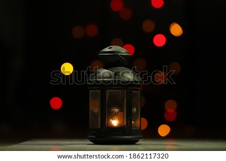 Christmas decor with candle and attractive blurred background  