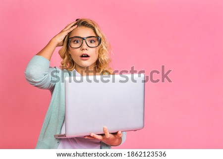 Excited little blonde teenager kid girl 12-13 years old isolated over pink background. Childhood lifestyle concept. Mock up copy space. Shocked amazed baby. 