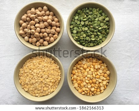 Round bowls with different legumes, peas, chickpeas and lentils on a white background. High quality photo
