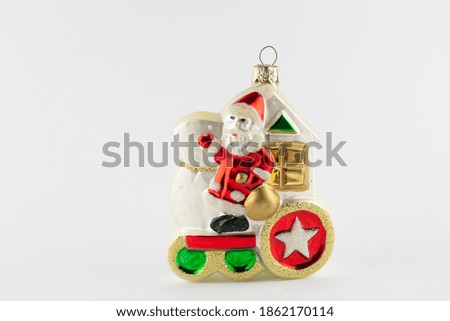a santa claus toy for christmas tree on white