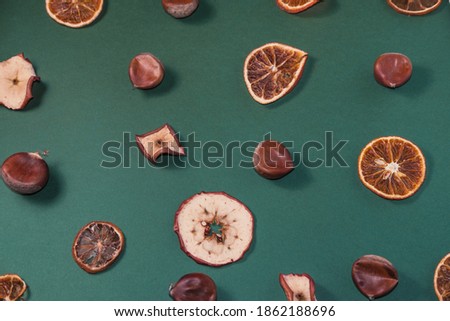 Dried fruits and chestnuts pattern on green background