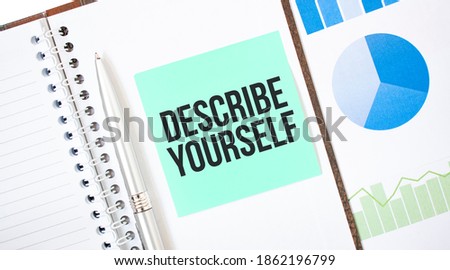 Green card on the white notepad. Text DESCRIBE YOURSELF. Business concept