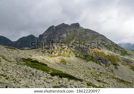 High rocky peaks national park of the High Tatras mountains with mountain Valley and sky with clouds. Slovakia  