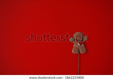 gingerbread man lies on a red background top view