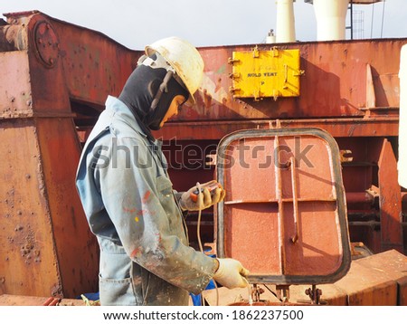a ship crew is checking the atmosphere in confined or enclosed space by multi-gas meter before entering. Royalty-Free Stock Photo #1862237500