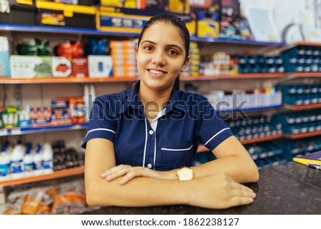 Young latin woman working in hardware store Royalty-Free Stock Photo #1862238127