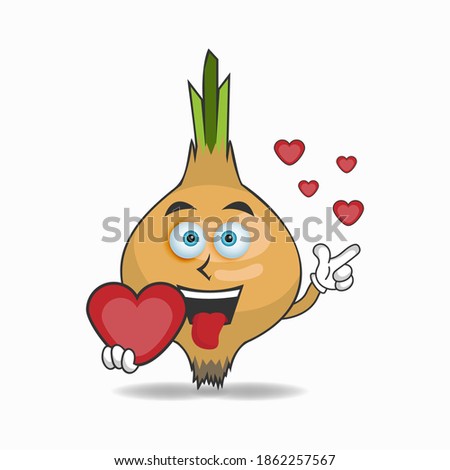 Garlic mascot character holding a love icon. vector illustration