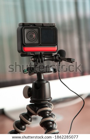 close up on the details of a small portable camera on a tripod with a microphone