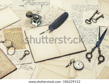 open diary book, antique accessories, old letters, inkwell and vintage feather ink pen. retro style toned picture