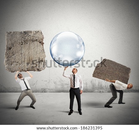 Concept of easy business with businessman holding a soap ball instead of the rock Royalty-Free Stock Photo #186231395