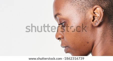 Shaved head black woman side profile