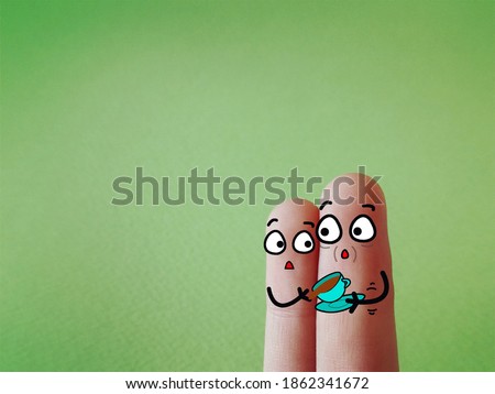 Two fingers are decorated as two person. One of them is an elderly. An old man accidentally spills his drink due to tremors.