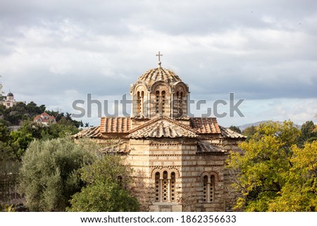 Greek Orthodox church in Athens, Greece. Aghios Athanasios church upper part in Thissio area, blue cloudy sky background
