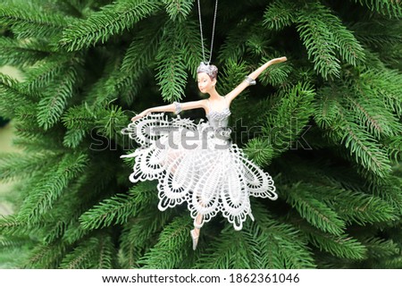 christmas card. ballerina toy figurine on christmas tree
