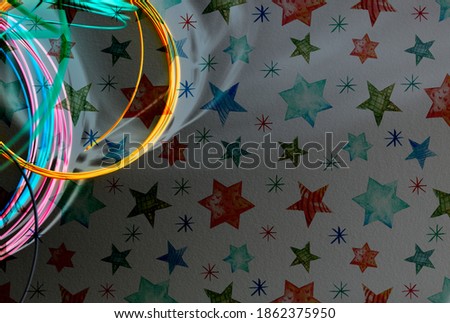 Abstract background with colored semicircles of thin fishing line, shadows on a dark gray background, colored stars drawn in chalk. Suitable for any inscriptions, banners, sales, screensavers.