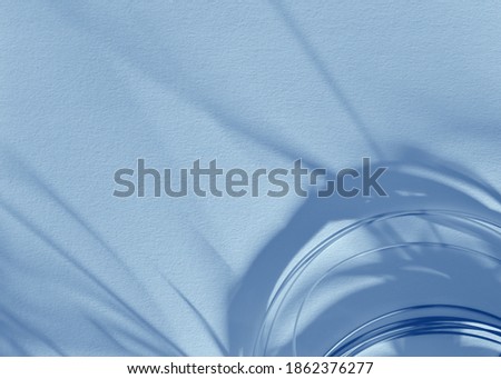 Abstract background with semicircles in the bottom corner, long gray shadows on white watercolor paper. In blue color. Empty space for text, ads, and other design tasks.