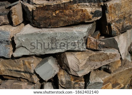 Pile of raw sandstone pieces from a quary. Natural building material.  Royalty-Free Stock Photo #1862402140