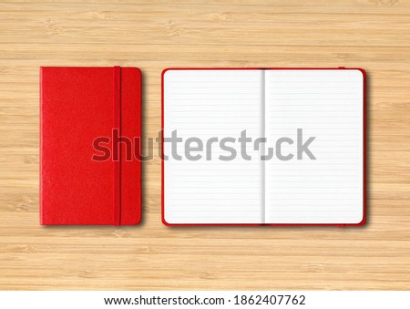 Red closed and open lined notebooks mockup isolated on wooden background